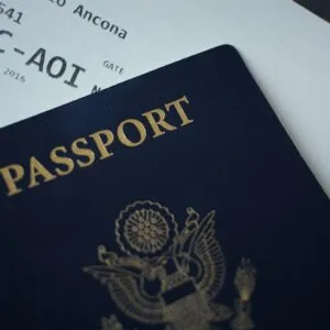 A navy passport lying on a printed boarding pass